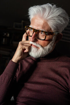Pensive Senior Man Wearing Glasses

