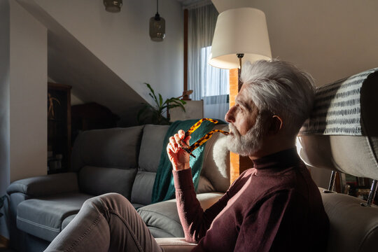 Thoughtful Senior Man Relaxing at Home