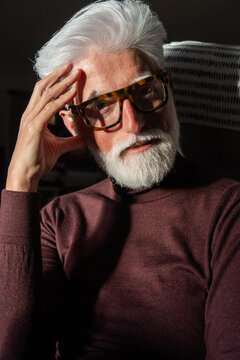 Thoughtful Senior Man Wearing Glasses