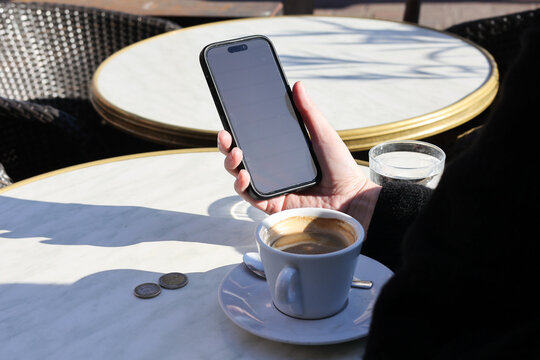 Anonymous model looking to smartphone in sunny day