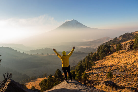 Hiker celebrating on top of mountain 