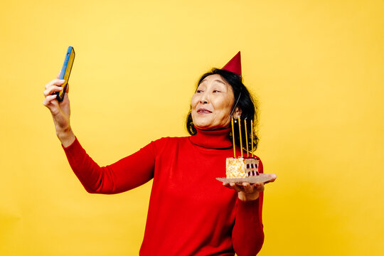 Senior Woman with Cake Having Birthday Video Call 