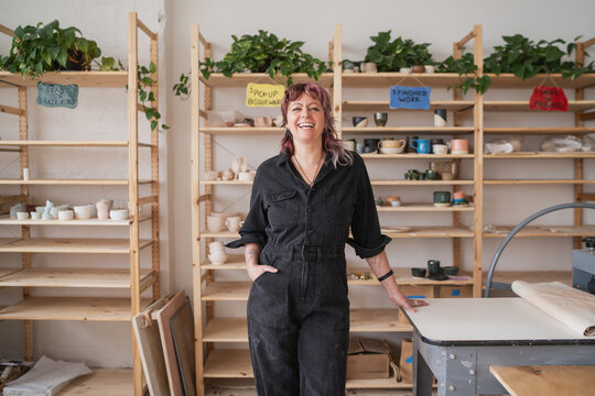 Smiling Potter Standing in Ceramics Studio  
