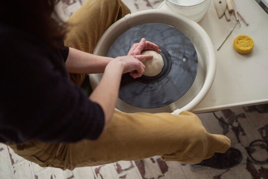 Hands Shaping Clay on Pottery Wheel  
