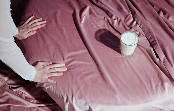 Anonymous Hands on Velvet Near Glass of Milk