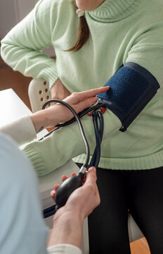 Doctor measures the patient's blood pressure