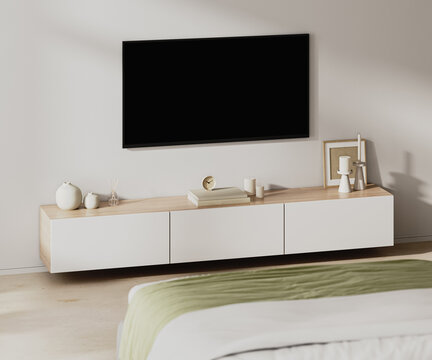 Room interior with TV screen in front of a bed