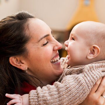 Portrait of a mother and her baby smiling