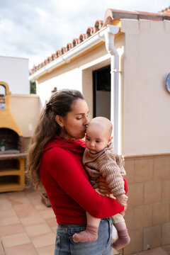 Mother kissing baby on forehead