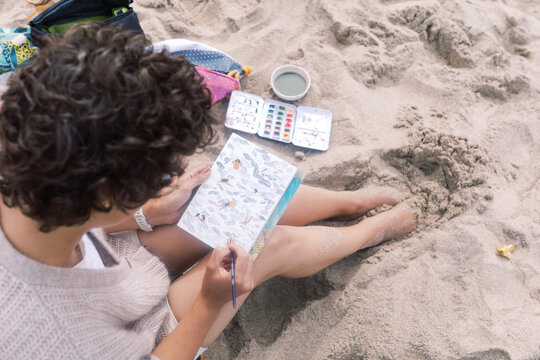  Woman Painting by the Ocean Coastal-Themed Postcard on Sand