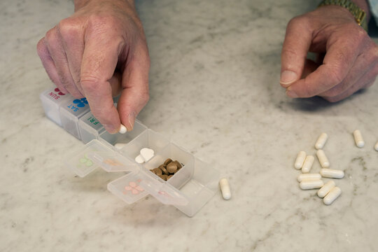 Organizing daily medications in a pill organizer at home