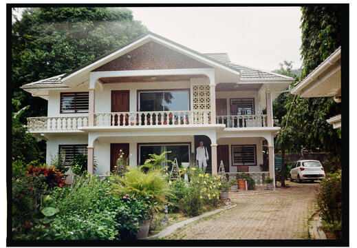 Beautiful house surrounded by lush garden in tropical setting