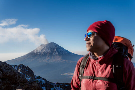 Mountaineer contemplating popocatepetl volcano