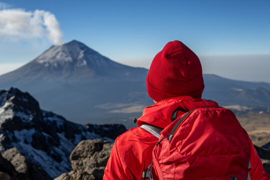 Mountaineer contemplating popocatepetl volcano 
