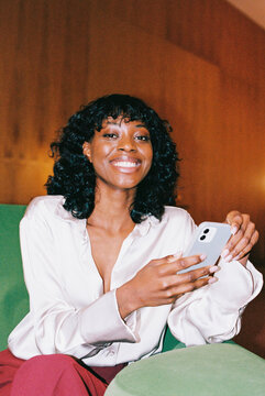 film photo portrait happy woman holding phone and smiling