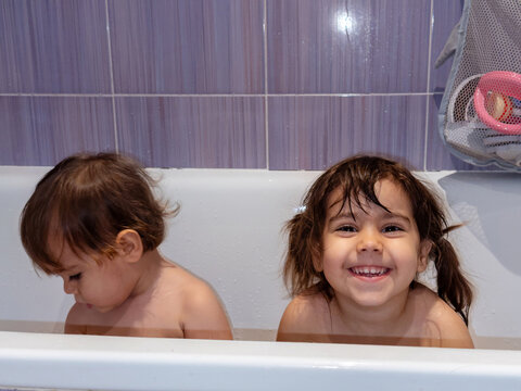 Two children enjoying bath time together