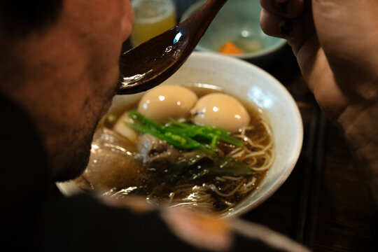 A man with beard eating ramen