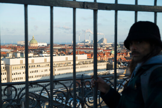 Young man on a watchtower in Kopenhagen 