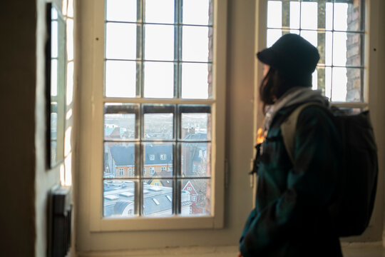 Young man at window in Kopenhagen 