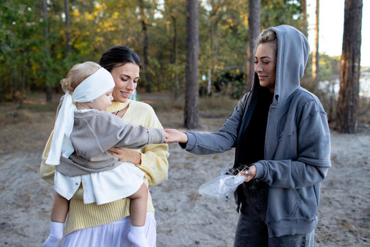 two women with a small child in nature