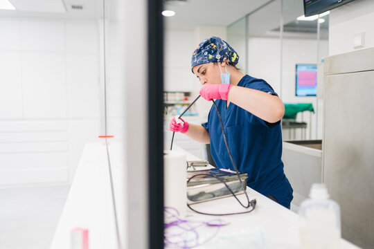 Veterinarian carefully cleaning and disinfecting endoscope