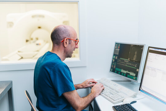 Veterinarian sitting at computer in MRI room
