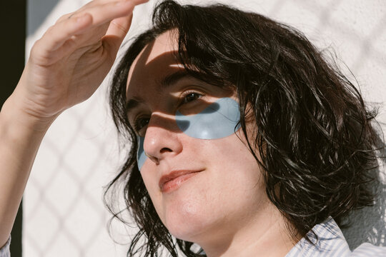 Close-Up of Woman Wearing Under-Eye Patches in Sunlight
