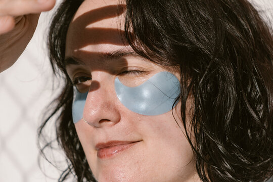 Close-Up of Woman Wearing Under-Eye Patches in Sunlight