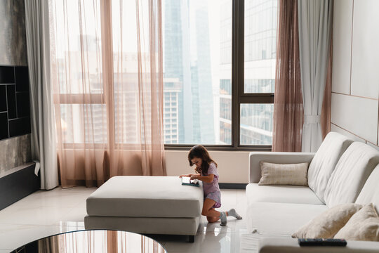 Child Playing with tablet in Living Room