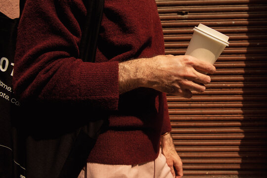 Anonymous Man Carrying A Tote Bag and Coffee Cup