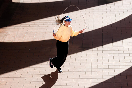 Sunlit Sporty Girl Skipping Rope 