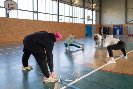 Positive Sporty Teenager Group Exercise Session in Gym