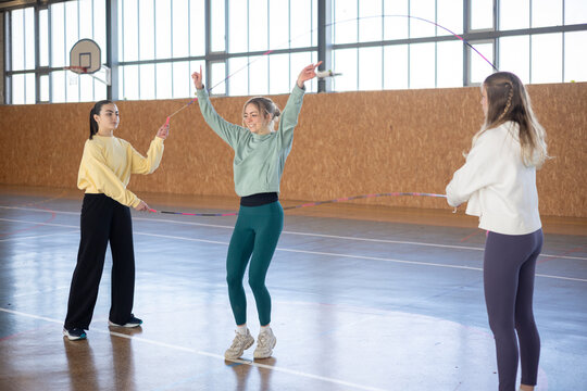 Girls Having Fun Enjoying Jump Rope Exercise in Gymnasium