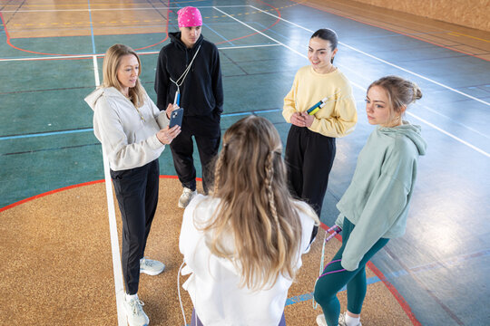 Young amateur sport team receiving instruction from coach