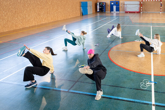 Positive Sporty Teenager Group Exercise Session in Gym