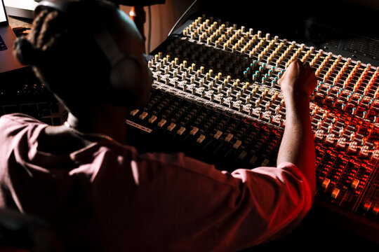 Man Producer Adjusting Soundboard Controls