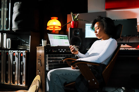 Woman Music Creator with Phone  in Recording Studio