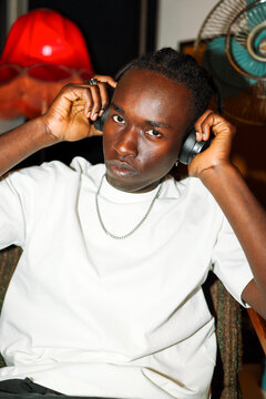 Portrait Man adjusting headphones with serious look