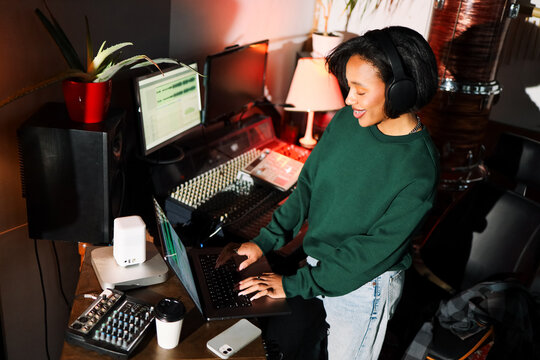 Woman Mixing Audio with Headphones On