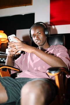 Music Producer Using Phone in Recording Space
