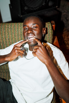 Portrait Stylish  Man flaunting metallic dental grillz