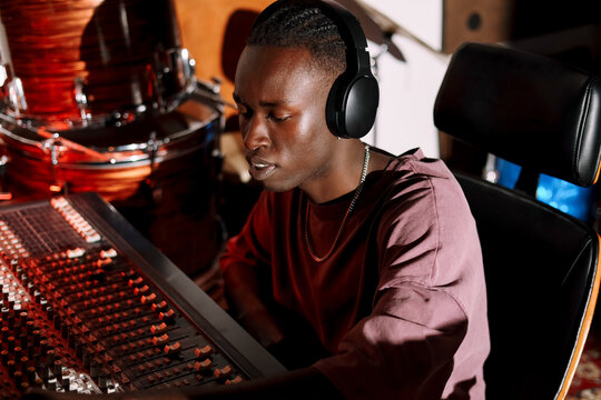 Man Adjusting Audio Levels in Studio