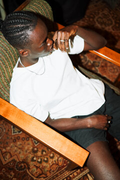 Stylish man relaxing in armchair