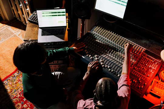 Man and Woman Mixing Music in Recording Studio