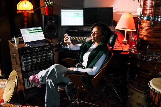 Smiling Woman Music Producer Checking Phone
