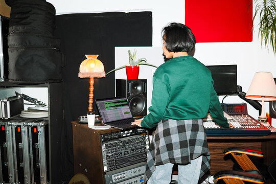 Music Producer Working on Laptop in Studio