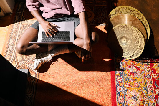 Creative workspace with laptop and cymbals