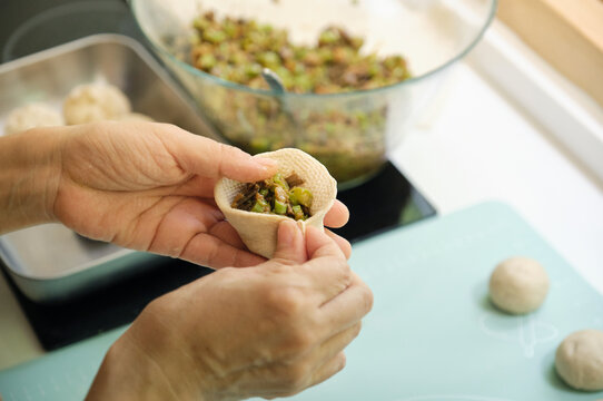 Closeup of hands making buns
