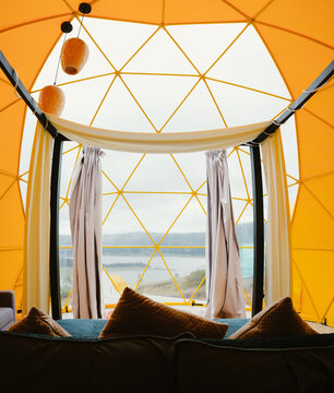 Cozy geodesic dome interior overlooking scenic lake view