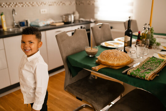 Boy in Formal Attire at Religious Ceremony Table